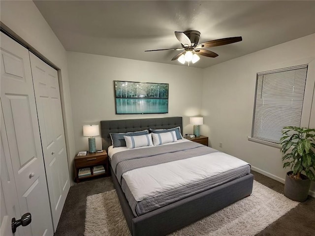 bedroom featuring ceiling fan, a closet, and dark colored carpet