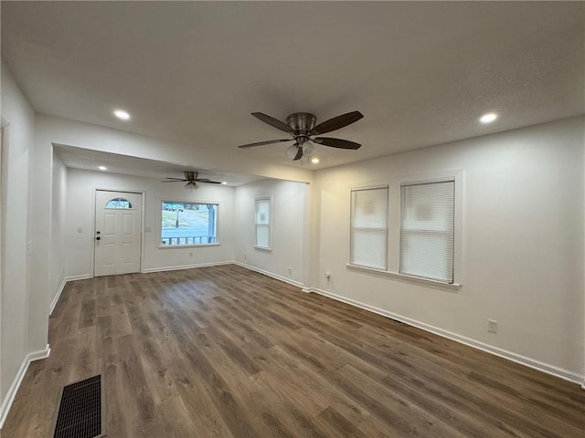 interior space with dark hardwood / wood-style floors and ceiling fan