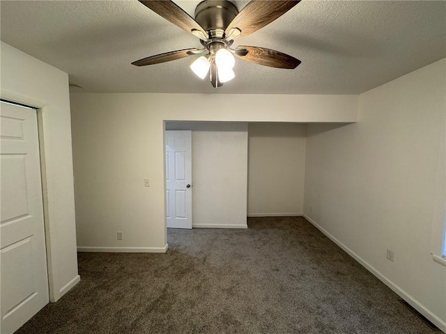 unfurnished bedroom featuring dark colored carpet, ceiling fan, a textured ceiling, and a closet