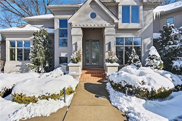 view of snow covered property entrance