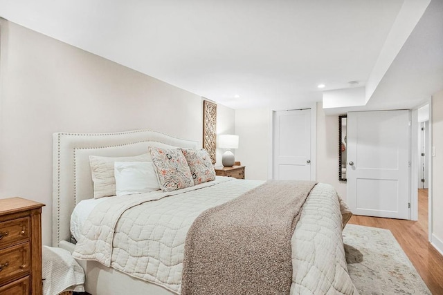 bedroom featuring light wood-type flooring and recessed lighting