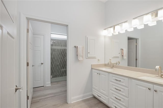 bathroom featuring vanity, hardwood / wood-style floors, and a shower with shower door