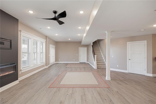 unfurnished living room with ceiling fan and light hardwood / wood-style flooring