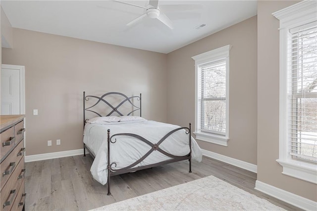 bedroom with light hardwood / wood-style floors and ceiling fan