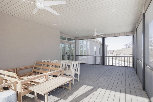 sunroom / solarium featuring ceiling fan