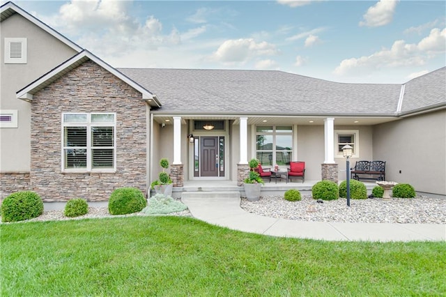 view of front of home with a front yard and covered porch