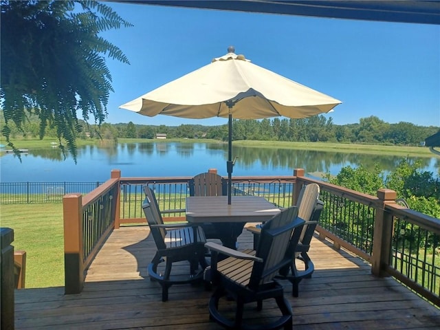 wooden terrace featuring a water view