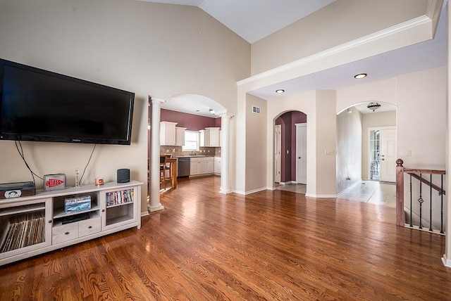 living room featuring sink, wood-type flooring, and lofted ceiling