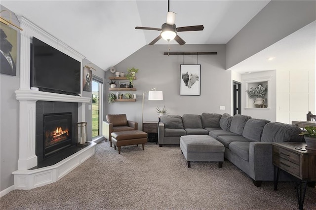 carpeted living room with ceiling fan, vaulted ceiling, and a fireplace