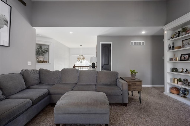 living room with built in shelves and dark carpet