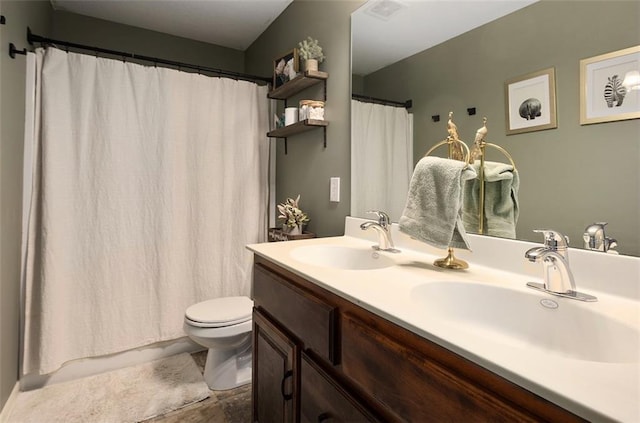 bathroom featuring toilet and vanity