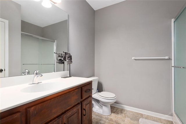 bathroom with toilet, a shower with shower door, and vanity