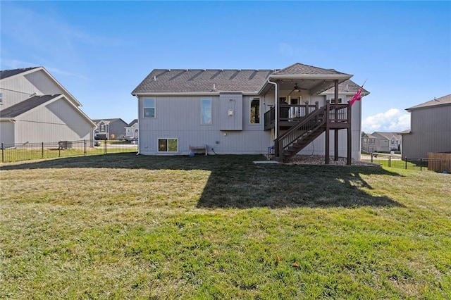 rear view of house featuring a deck, ceiling fan, and a yard