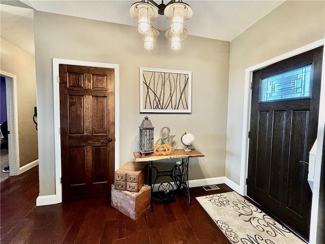 entryway featuring hardwood / wood-style flooring and a chandelier