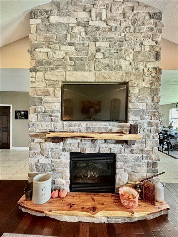 room details featuring wood-type flooring, a fireplace, and a textured ceiling