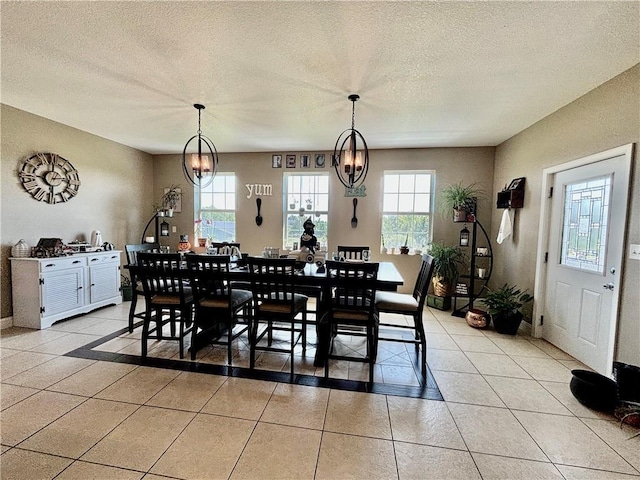 dining room with an inviting chandelier, a healthy amount of sunlight, and light tile patterned floors