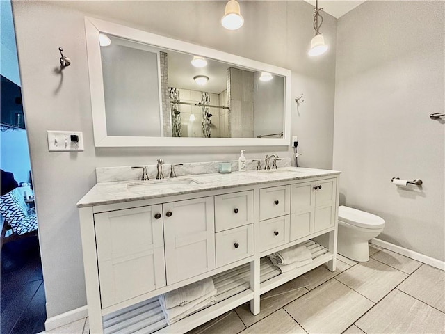 bathroom featuring a shower, vanity, and toilet