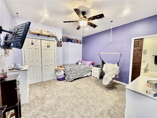 carpeted bedroom featuring ceiling fan and a closet