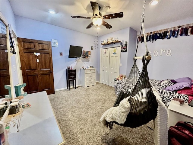 bedroom with carpet, ceiling fan, and a closet