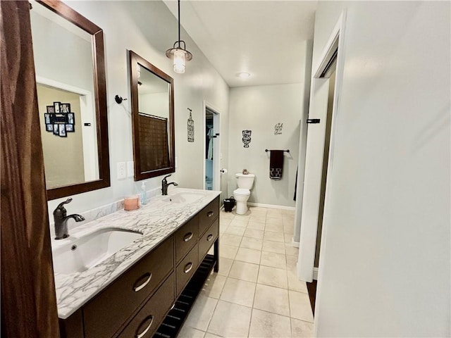 bathroom with tile patterned flooring, vanity, and toilet