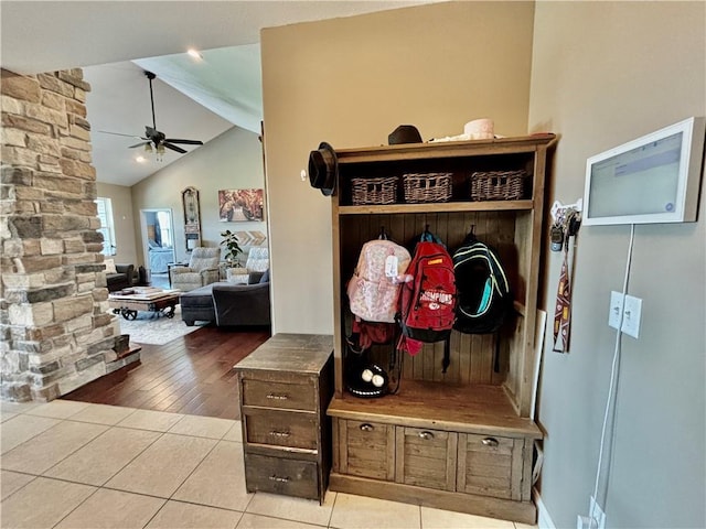 mudroom with light tile patterned floors, lofted ceiling with beams, and ceiling fan