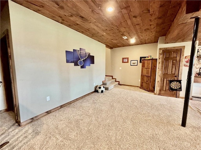 interior space with wood ceiling and carpet