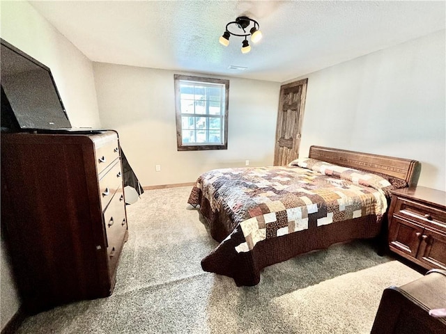 carpeted bedroom featuring a textured ceiling