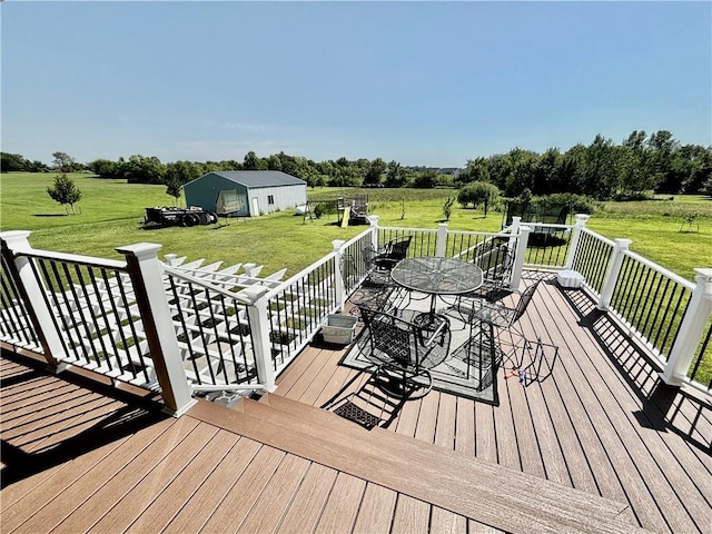 wooden terrace featuring a yard and a rural view