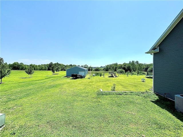 view of yard with central AC, a rural view, and a trampoline