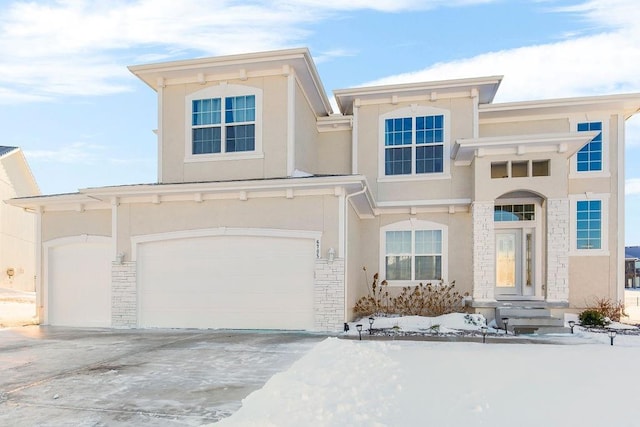 view of front of house featuring concrete driveway, a garage, stone siding, and stucco siding