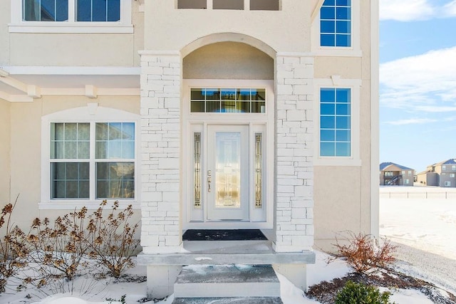 property entrance with stucco siding