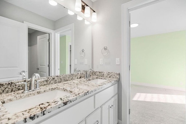 full bathroom with double vanity and a sink