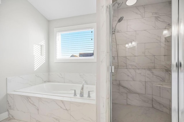 full bathroom featuring a stall shower and a bath