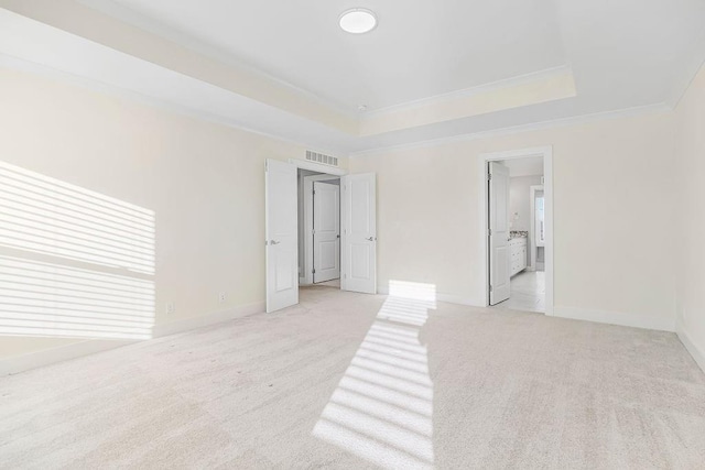 bedroom featuring baseboards, visible vents, crown molding, light carpet, and a raised ceiling