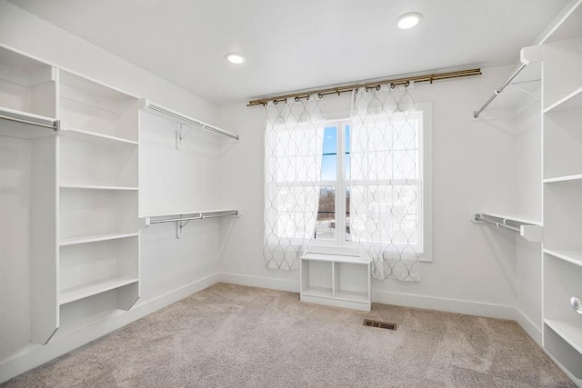 walk in closet featuring visible vents and carpet floors