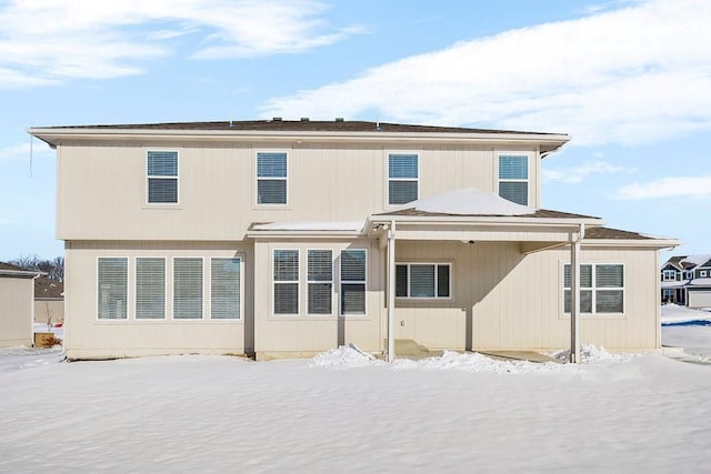 view of snow covered rear of property