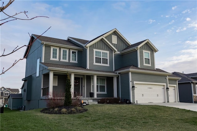 view of front facade featuring a front yard, a porch, and a garage