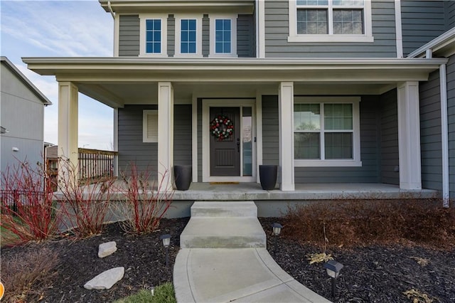 view of exterior entry featuring a porch