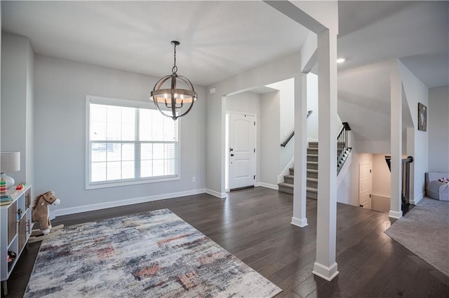 foyer entrance featuring dark hardwood / wood-style flooring and a chandelier