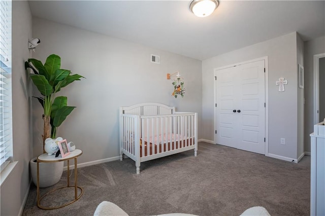 carpeted bedroom with a nursery area