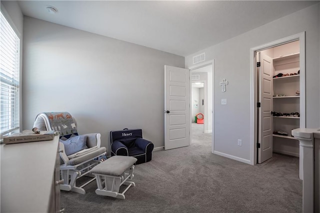 living area with carpet and a healthy amount of sunlight