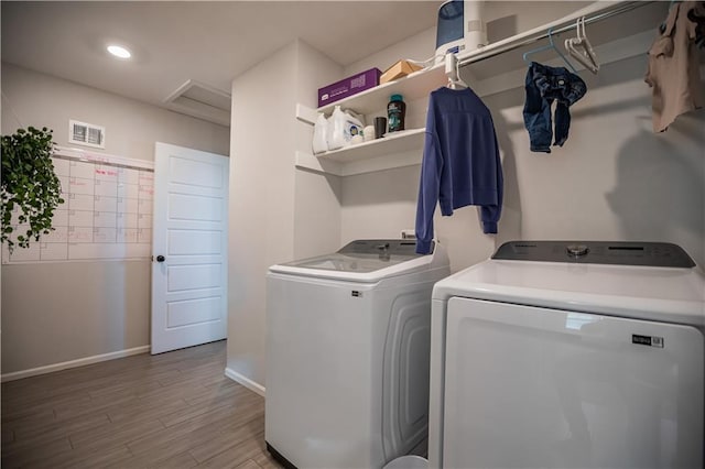 washroom featuring hardwood / wood-style floors and washer and dryer