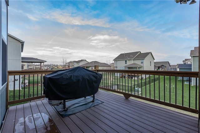 deck with a grill and a yard