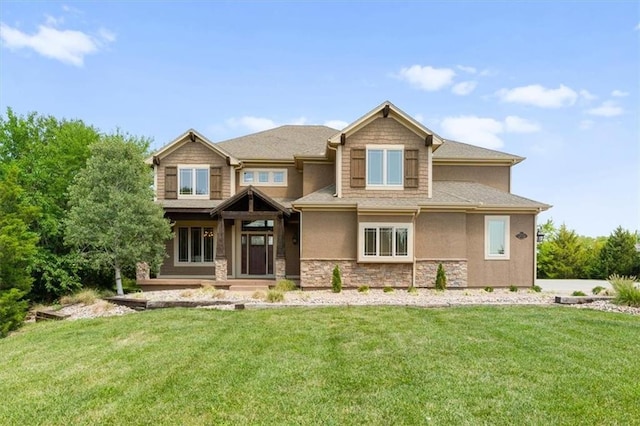 view of front of property with stone siding, a front lawn, and stucco siding