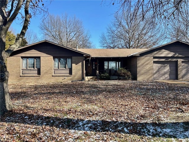 view of front of home with a garage and brick siding