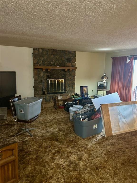 carpeted living room featuring a textured ceiling and a fireplace