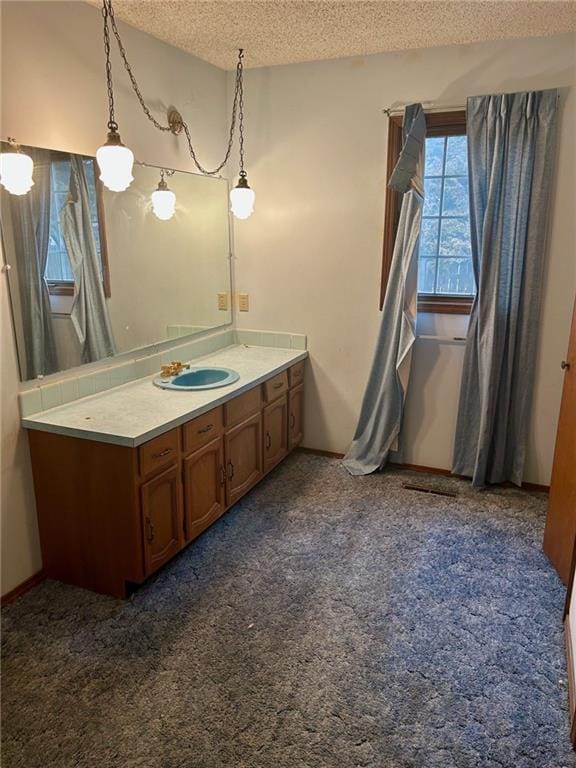 bathroom featuring a textured ceiling and vanity