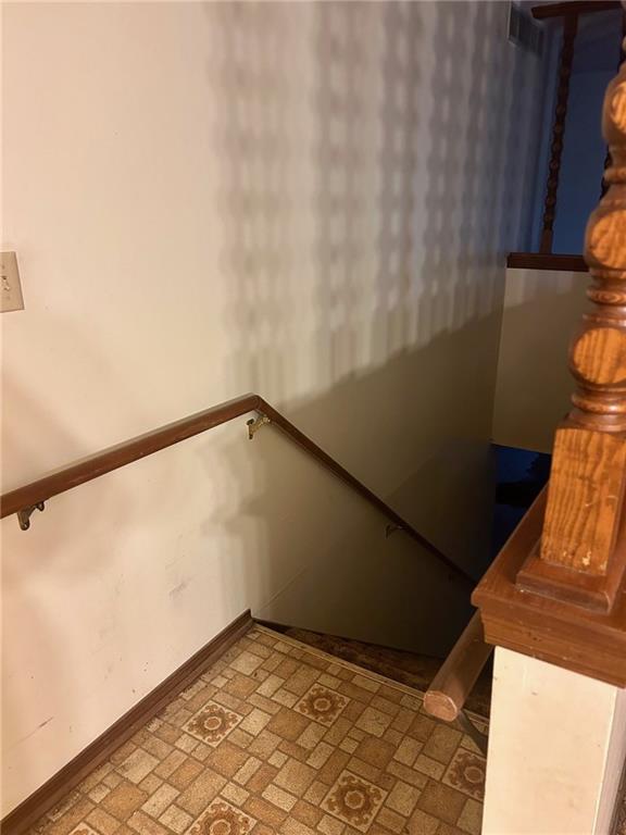 staircase featuring baseboards