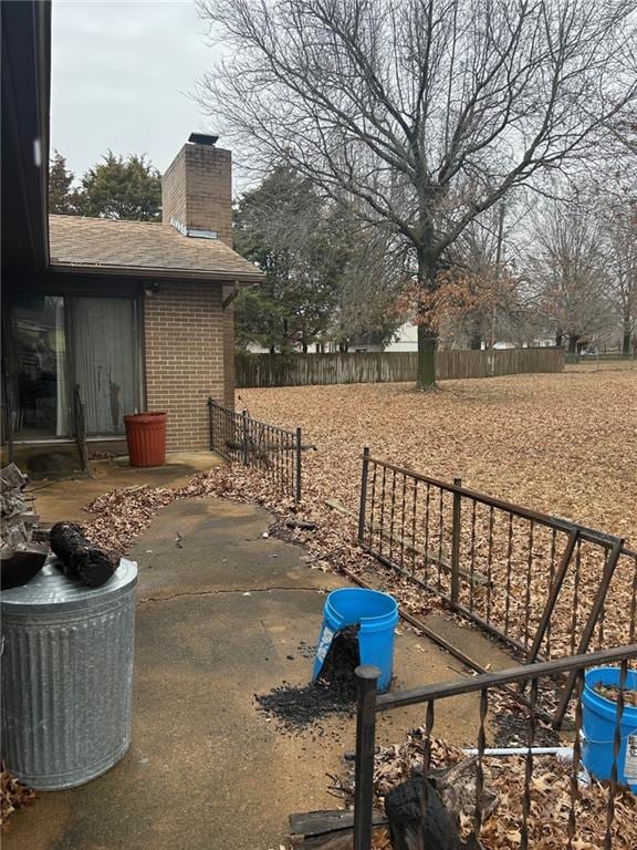 view of yard featuring fence and a patio