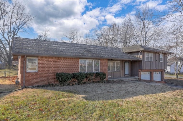 tri-level home featuring a front lawn and a garage